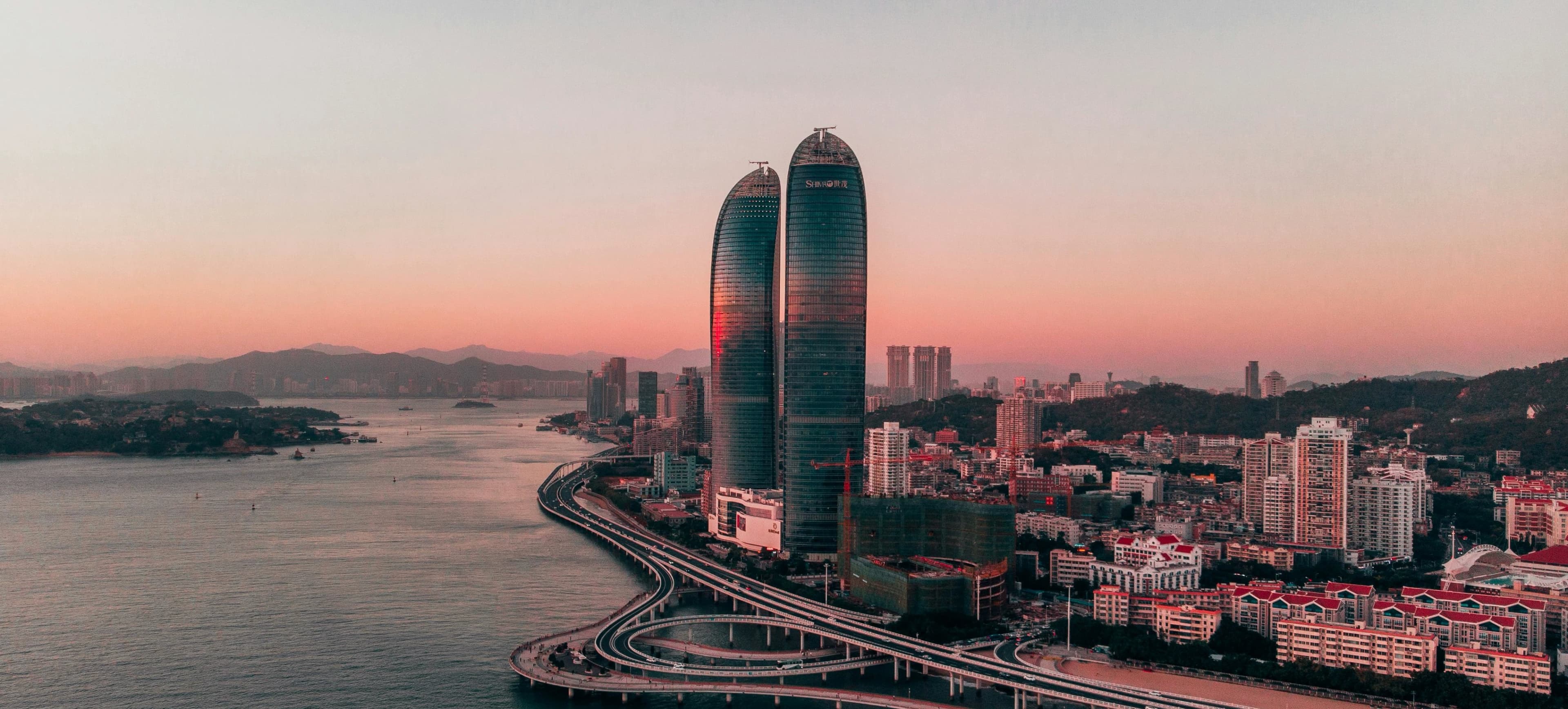 A panoramic view of Xiamen's skyline with the sea and Gulangyu Island in the distance